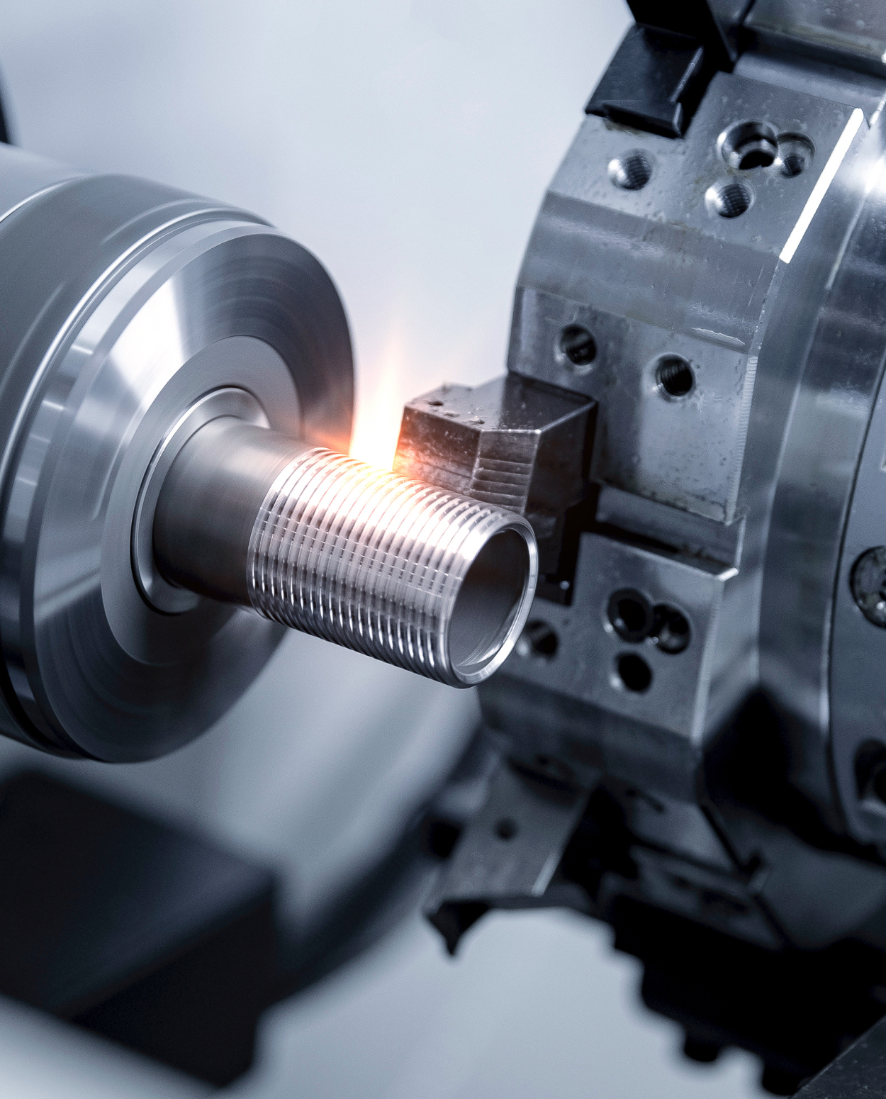 a machine cutting a metal tube