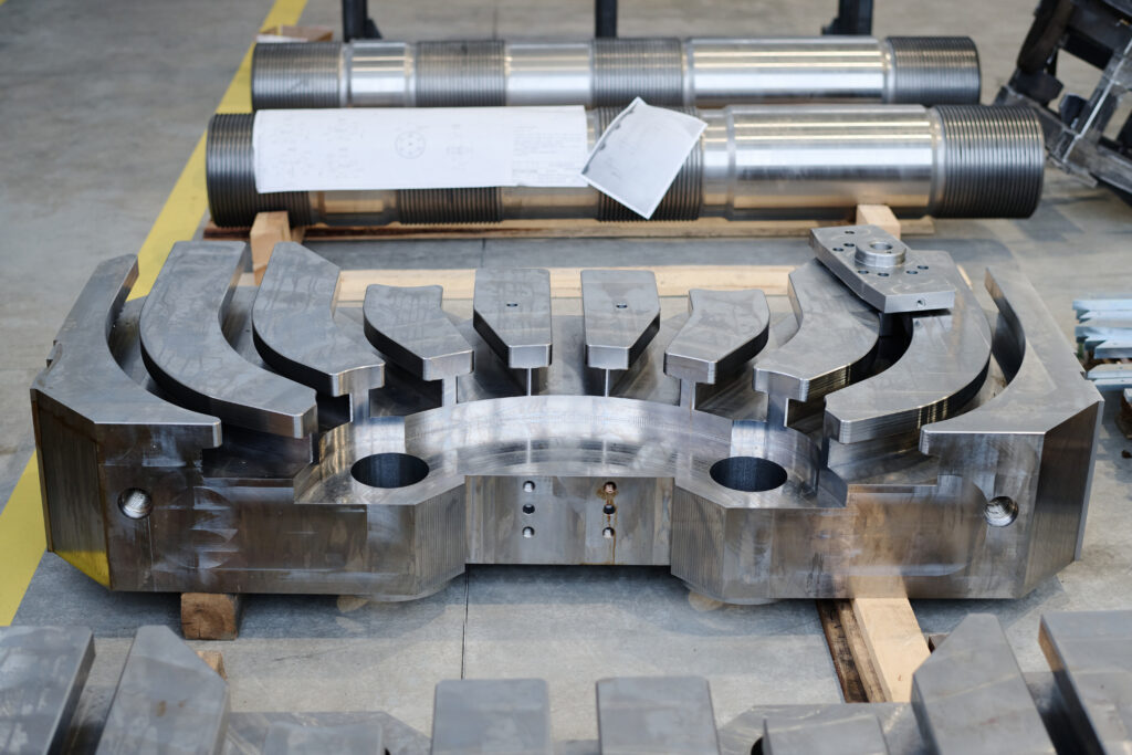 Industrial metal parts produced in modern metalwork factory, copy space